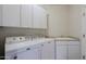 Laundry room with washer, dryer, and cabinets at 1828 W Owens Way, Anthem, AZ 85086