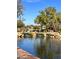 Serene pond with waterfall feature and landscaping at 1828 W Owens Way, Anthem, AZ 85086