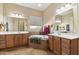 Double vanity bathroom with soaking tub and tile flooring at 18311 W East Wind Ave, Goodyear, AZ 85338