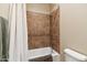 Bathroom with shower/tub combo and tile surround at 18311 W East Wind Ave, Goodyear, AZ 85338