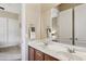 Double vanity bathroom with a large mirror at 18311 W East Wind Ave, Goodyear, AZ 85338