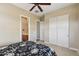 Bedroom with a queen bed, ceiling fan and en-suite bathroom at 18311 W East Wind Ave, Goodyear, AZ 85338