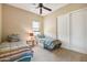 Bedroom with two twin beds, ceiling fan, and window at 18311 W East Wind Ave, Goodyear, AZ 85338