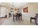 Bright dining room with table and chairs, and access to living room at 18311 W East Wind Ave, Goodyear, AZ 85338