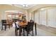 Elegant dining room features a wooden table and chairs, and a view into the living room at 18311 W East Wind Ave, Goodyear, AZ 85338