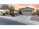 Green house with stone accents and desert landscaping at 18311 W East Wind Ave, Goodyear, AZ 85338