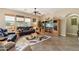 Relaxing living room with leather furniture, a large TV, and plenty of natural light at 18311 W East Wind Ave, Goodyear, AZ 85338