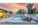 Relaxing pool area with patio furniture and stunning sunset views at 18311 W East Wind Ave, Goodyear, AZ 85338