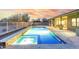 L-shaped pool with spa and expansive patio at 18311 W East Wind Ave, Goodyear, AZ 85338