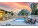 Inviting backyard pool with seating area and mountain views at 18311 W East Wind Ave, Goodyear, AZ 85338