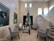 Two-story foyer with high ceilings, Christmas tree, and seating area at 18656 W Raymond St, Goodyear, AZ 85338