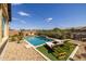 Relaxing backyard oasis featuring a sparkling pool, comfortable loungers, and a water feature at 19447 S 209Th Pl, Queen Creek, AZ 85142