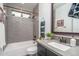 Clean bathroom with gray tile, a tub, and a modern vanity at 19447 S 209Th Pl, Queen Creek, AZ 85142