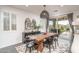 Bright dining area with wooden table, black chairs, and access to the backyard at 19447 S 209Th Pl, Queen Creek, AZ 85142