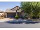 Single-story home with a two-car garage and landscaped front yard at 19447 S 209Th Pl, Queen Creek, AZ 85142