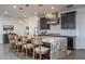 Modern kitchen with granite island, stainless steel appliances, and stylish light fixtures at 19447 S 209Th Pl, Queen Creek, AZ 85142