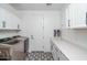 Spacious laundry room with white cabinets, washer and dryer at 19447 S 209Th Pl, Queen Creek, AZ 85142