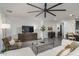 Light and airy living room with a sectional sofa, a coffee table, and a view to the kitchen at 19447 S 209Th Pl, Queen Creek, AZ 85142