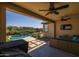 Covered patio with outdoor seating, ceiling fans, and a view of the pool at 19447 S 209Th Pl, Queen Creek, AZ 85142