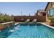 Inviting pool area with water feature and comfortable lounge chairs at 19447 S 209Th Pl, Queen Creek, AZ 85142