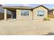 Tan house with covered patio and spacious backyard at 19583 W Cheery Lynn Rd, Buckeye, AZ 85396