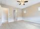 Primary bedroom with carpeted floors, ceiling fan and en-suite bathroom at 19583 W Cheery Lynn Rd, Buckeye, AZ 85396