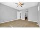 Spacious bedroom with ceiling fan and neutral walls at 19583 W Cheery Lynn Rd, Buckeye, AZ 85396