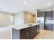 Modern kitchen with an island, stainless steel appliances, and white countertops at 19583 W Cheery Lynn Rd, Buckeye, AZ 85396