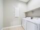 Laundry room with washer, dryer, and overhead shelving at 19583 W Cheery Lynn Rd, Buckeye, AZ 85396