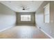 Bright living room with wood-look tile floors and ceiling fan at 19583 W Cheery Lynn Rd, Buckeye, AZ 85396