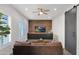 Gathering room with leather sofa, wood wall, and barn door at 19780 E Ivy Ln, Queen Creek, AZ 85142