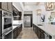 Modern kitchen with stainless steel appliances and dark cabinetry at 19780 E Ivy Ln, Queen Creek, AZ 85142