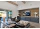 Living area with leather sectional, wood feature wall, and built-in entertainment center at 19780 E Ivy Ln, Queen Creek, AZ 85142