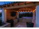 Covered patio with an outdoor kitchen, grill, and large TV at 19780 E Ivy Ln, Queen Creek, AZ 85142