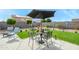 Backyard patio with artificial turf and a small dining set at 20017 W Jackson St, Buckeye, AZ 85326