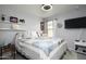 Cozy bedroom with a queen-size bed, TV, and decorative shelving at 20017 W Jackson St, Buckeye, AZ 85326