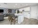 White kitchen with an island and gray bar stools at 20017 W Jackson St, Buckeye, AZ 85326