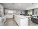 Open kitchen features white cabinets, an island, and views into the living area at 20017 W Jackson St, Buckeye, AZ 85326