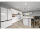 Modern kitchen with white cabinets, island, and stainless steel appliances at 20017 W Jackson St, Buckeye, AZ 85326