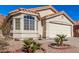 Tan stucco house with tile roof, two-car garage, and desert landscaping at 2018 E Glenhaven Dr, Phoenix, AZ 85048