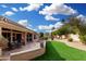 Landscaped backyard featuring a patio and green lawn at 20426 N 133Rd Dr, Sun City West, AZ 85375