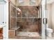 Large walk-in shower with tiled walls and built-in seat at 20426 N 133Rd Dr, Sun City West, AZ 85375