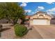 Single-story home with a two-car garage and landscaped front yard at 20426 N 133Rd Dr, Sun City West, AZ 85375