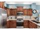 Spacious kitchen with granite countertops and dark wood cabinets at 20426 N 133Rd Dr, Sun City West, AZ 85375