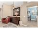 Living room featuring a leather chair and wooden cabinet at 20426 N 133Rd Dr, Sun City West, AZ 85375