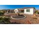 Backyard featuring desert landscaping, a modern patio area, and a built-in outdoor kitchen at 22901 E Quintero Rd, Queen Creek, AZ 85142