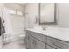 Bathroom featuring white vanity with gray cabinets, shower over bath tub and large mirror at 22901 E Quintero Rd, Queen Creek, AZ 85142