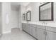 Elegant bathroom featuring dual sinks, gray cabinetry, and tile flooring at 22901 E Quintero Rd, Queen Creek, AZ 85142