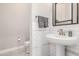 A half bathroom showing a pedestal sink with brushed nickel faucet, toilet, and white subway tile backsplash at 22901 E Quintero Rd, Queen Creek, AZ 85142