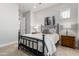 Comfortable bedroom featuring a metal bed frame, carpeted flooring, and neutral decor at 22901 E Quintero Rd, Queen Creek, AZ 85142